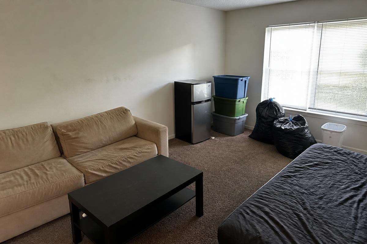 Student rental living room left full of furniture and trash bags before removal in Boiling Springs, NC