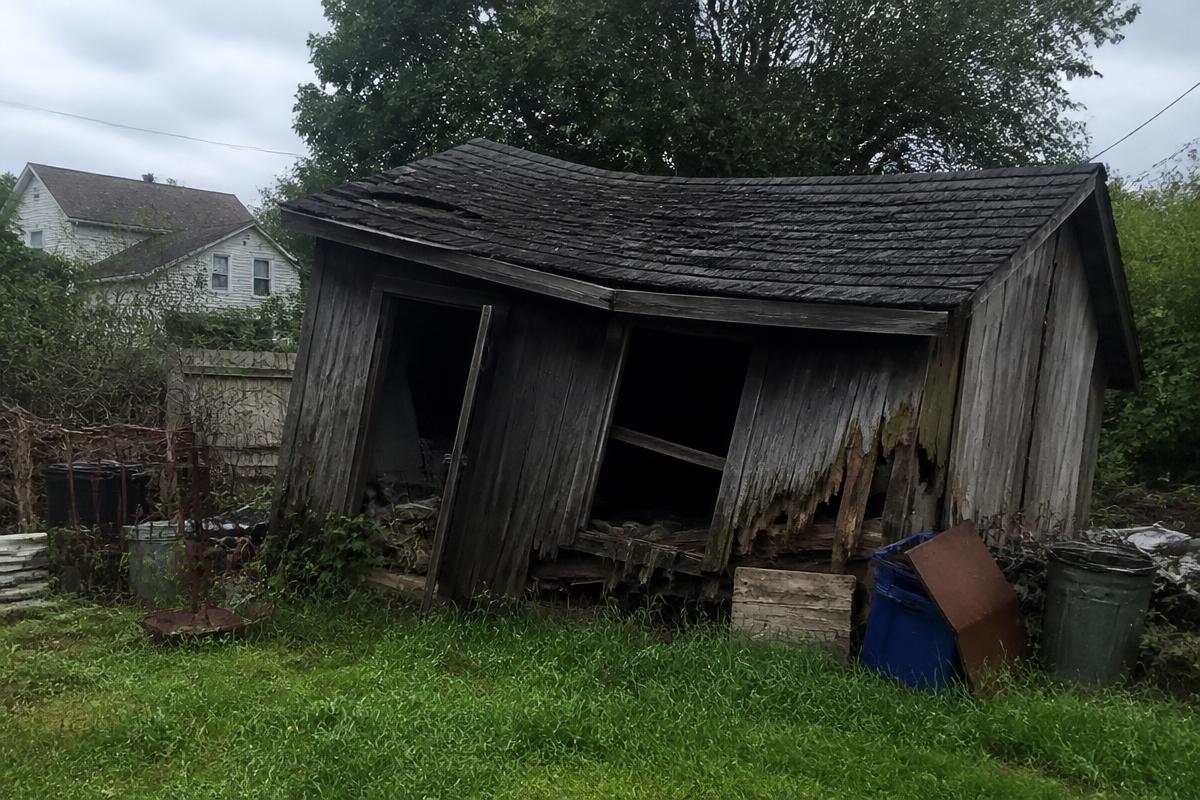 Collapsing wooden backyard shed with rotted siding before teardown in Cherryville, NC