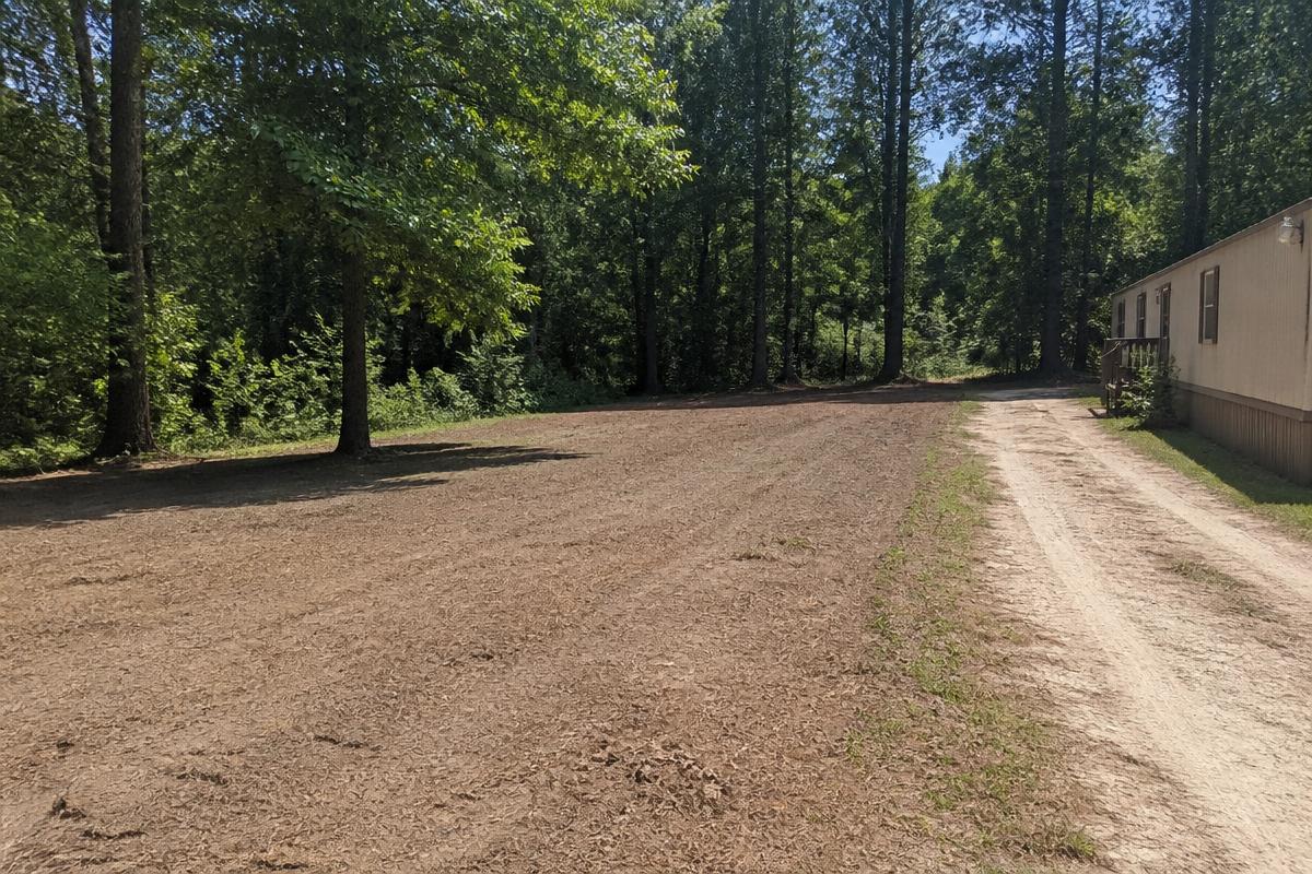 Same rural lot cleared and raked after property cleanup in Grover, NC
