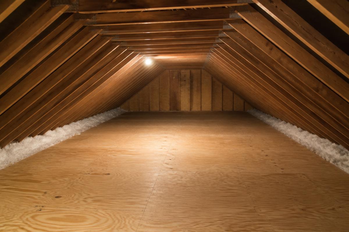 Same attic emptied down to bare plywood decking after junk removal in Rutherfordton, NC